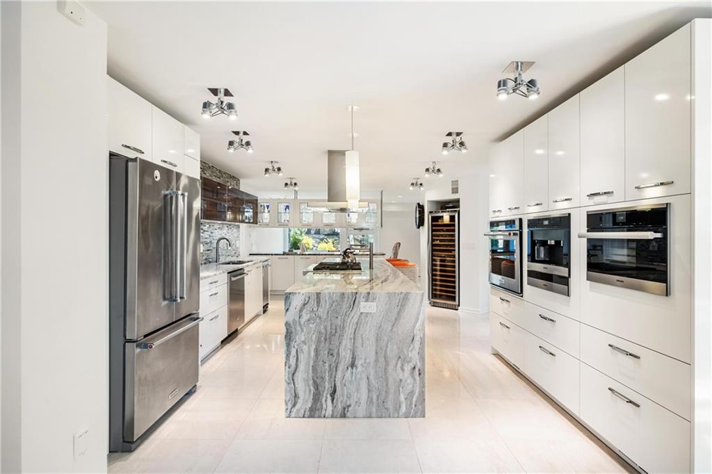 2437 Mt Royal Road Pittsburgh, PA 15217 - Photo 17 of 39 a kitchen with stainless steel appliances kitchen island granite countertop a refrigerator and cabinets