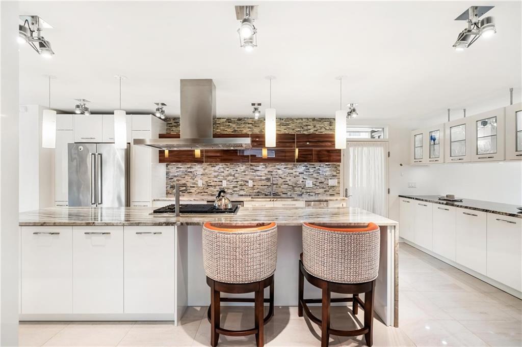2437 Mt Royal Road Pittsburgh, PA 15217 - Photo 19 of 39 a kitchen with stainless steel appliances granite countertop a sink and a refrigerator