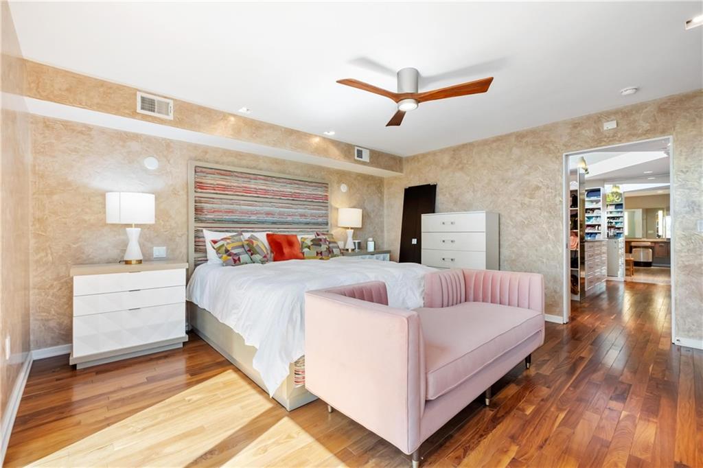 2437 Mt Royal Road Pittsburgh, PA 15217 - Photo 23 of 39 a bedroom with a large bed and a chandelier