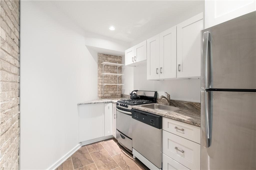 2437 Mt Royal Road Pittsburgh, PA 15217 - Photo 31 of 39 a kitchen with granite countertop white cabinets and white appliances