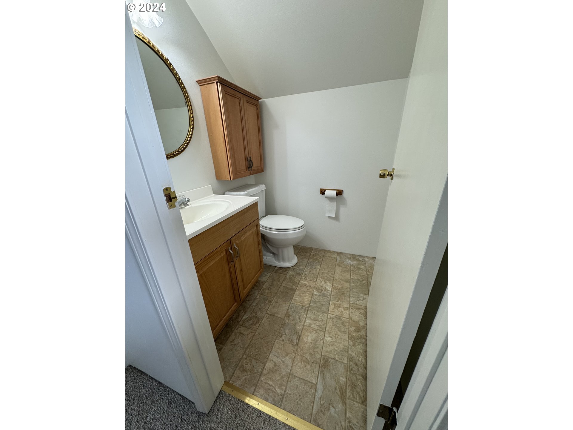 508 3rd Avenue Dallesport, WA 98617 - Photo 20 of 48 a bathroom with a sink and mirror with toilet