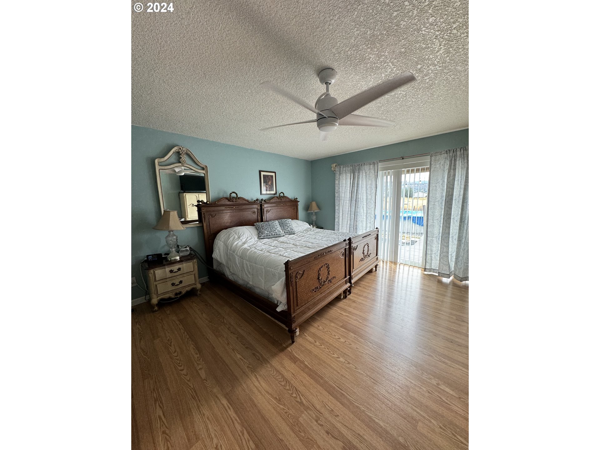 508 3rd Avenue Dallesport, WA 98617 - Photo 5 of 48 a spacious bedroom with a bed and a chandelier