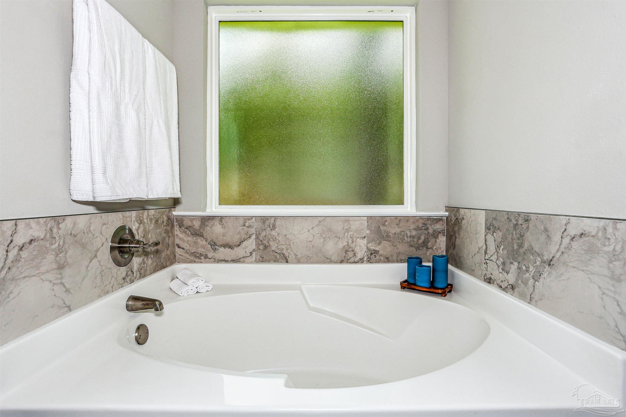 3494 Doyle Hawkins Road Navarre, FL 32566 - Photo 20 of 30 a bathroom with sink and bathtub