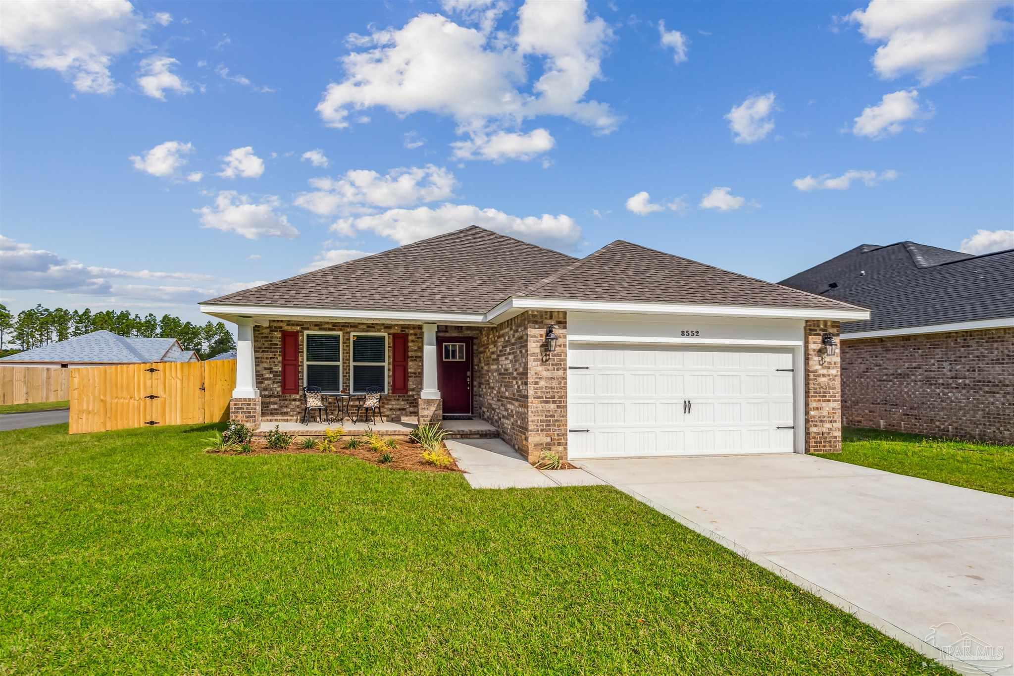 3494 Doyle Hawkins Road Navarre, FL 32566 - Photo 29 of 30 a front view of a house with a garden and yard