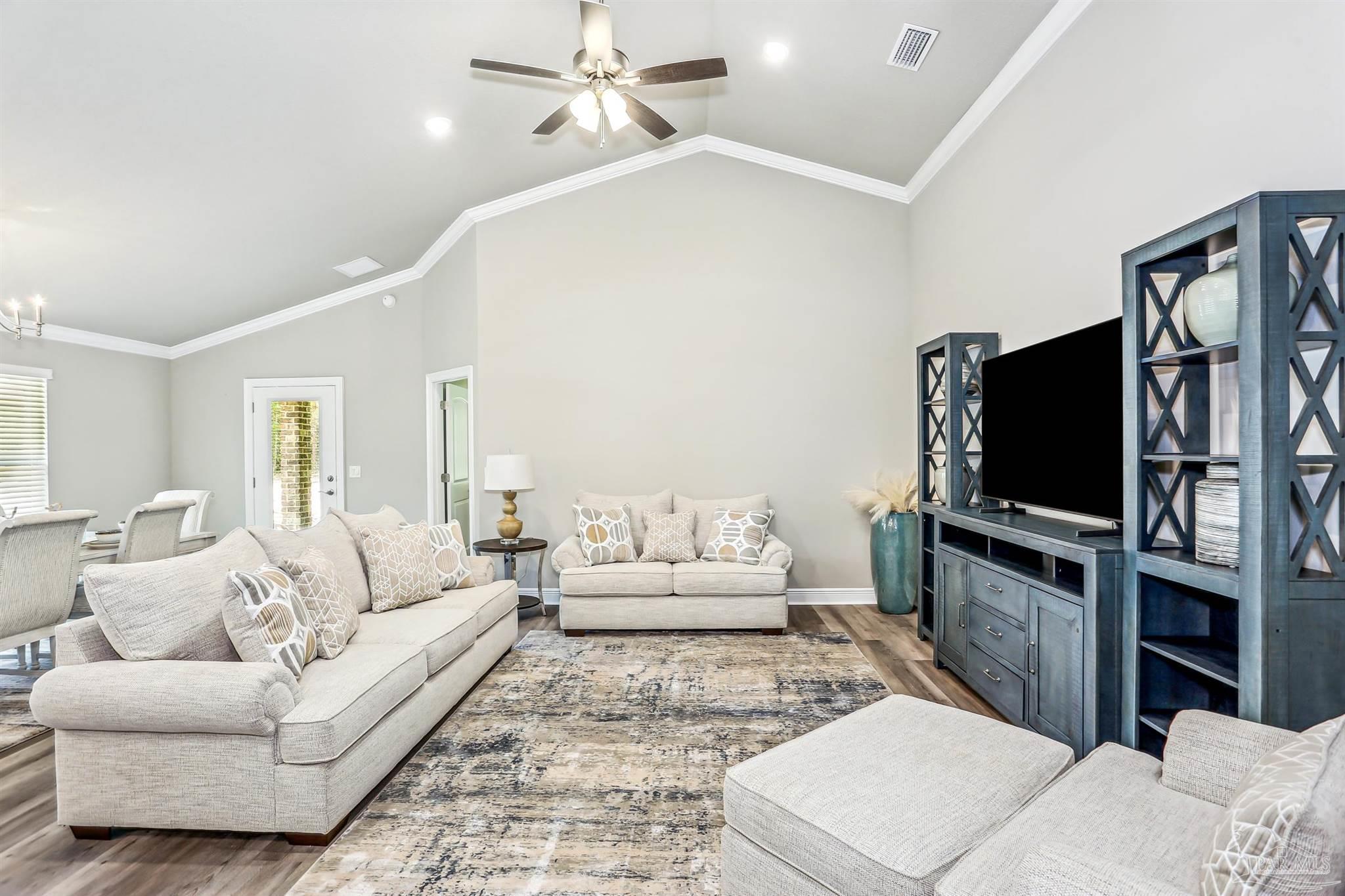 3494 Doyle Hawkins Road Navarre, FL 32566 - Photo 6 of 30 a living room with furniture and a flat screen tv