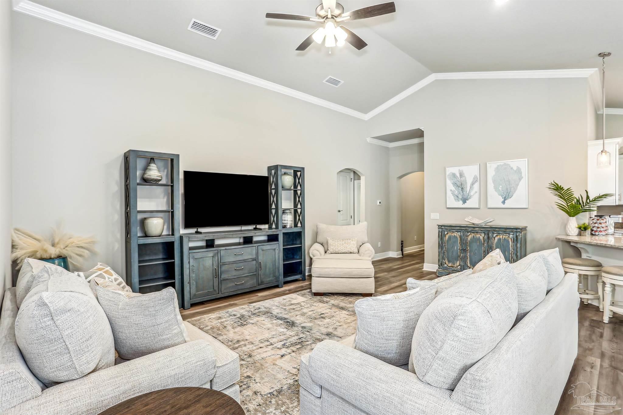 3494 Doyle Hawkins Road Navarre, FL 32566 - Photo 7 of 30 a living room with furniture and a flat screen tv