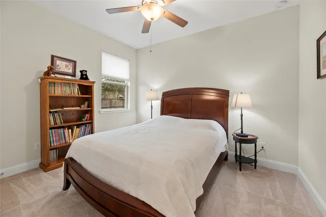 a bedroom with a bed and a bookshelf