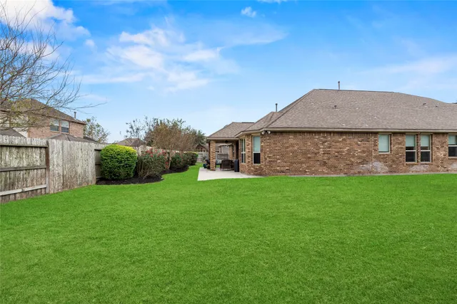 a aerial view of a house with a yard and potted plants