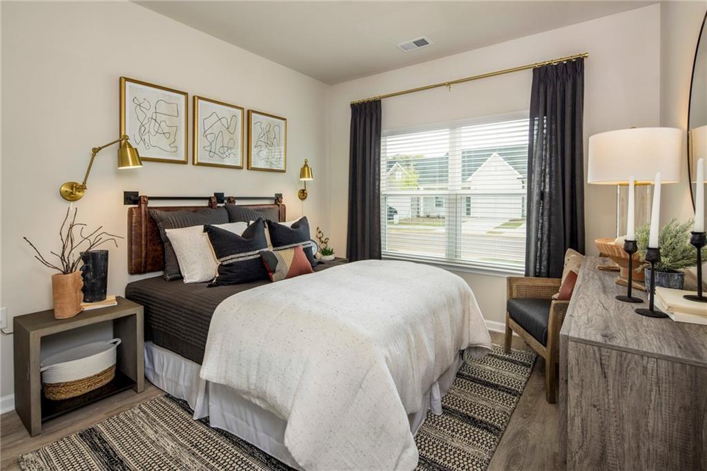 100 Cottage Way, Unit CARAWAY Hampton, GA 30228 - Photo 28 of 44 a bed room with a bed and a chair