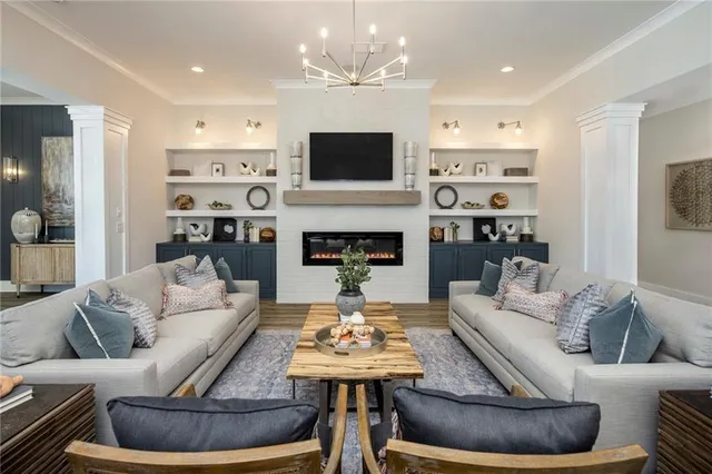 a living room with furniture a fireplace and a flat screen tv