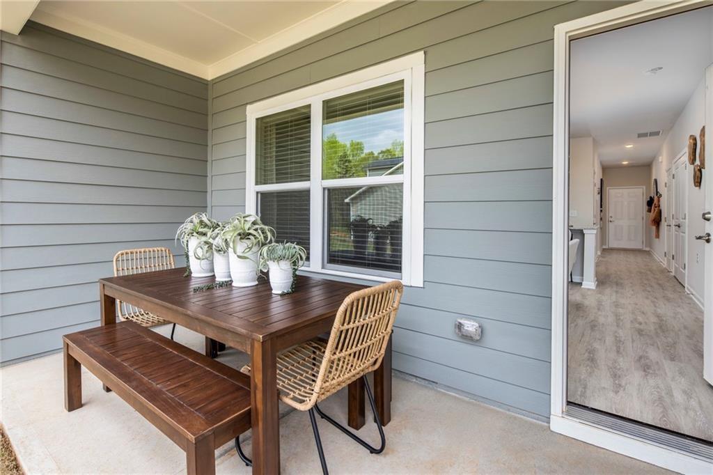 100 Cottage Way, Unit CARAWAY Hampton, GA 30228 - Photo 40 of 44 a view of a dining room with furniture and window