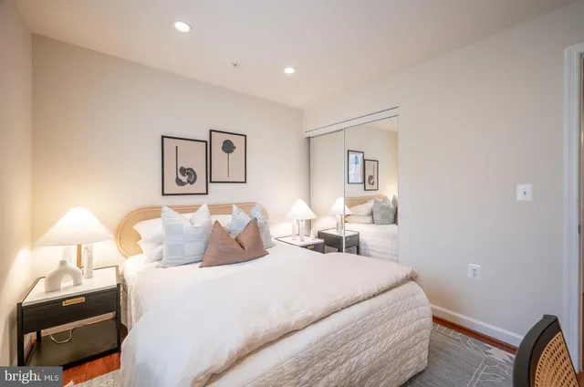 a bedroom with a bed and a lamp