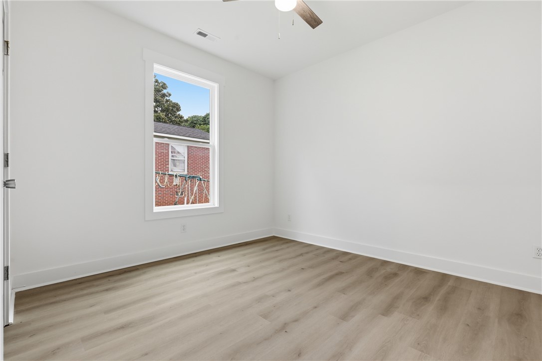 403 Tribble Street Seneca, SC 29678 - Photo 20 of 37 A well-lit bedroom features durable laminate flooring and a refreshing ceiling fan.