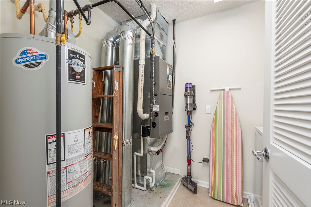 3967 Gardiner Run Akron, OH 44321 - Photo 30 of 35 Utility room featuring gas water heater