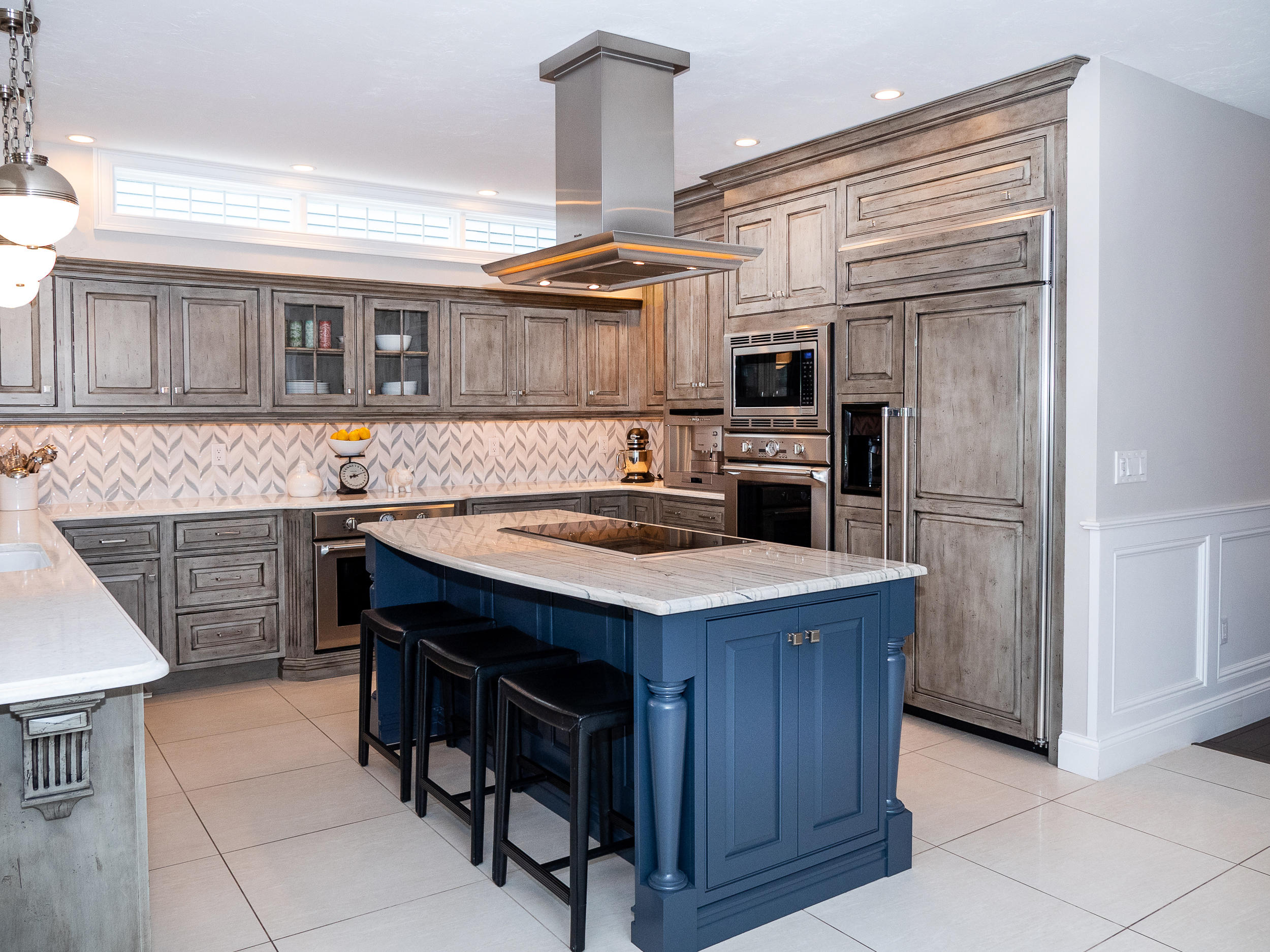 a kitchen with kitchen island a cabinets counter top space and stainless steel appliances