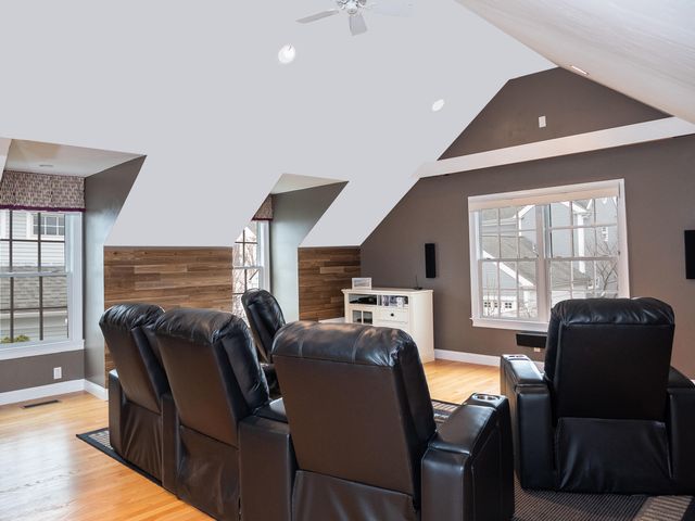 a living room with furniture a flat screen tv and large windows