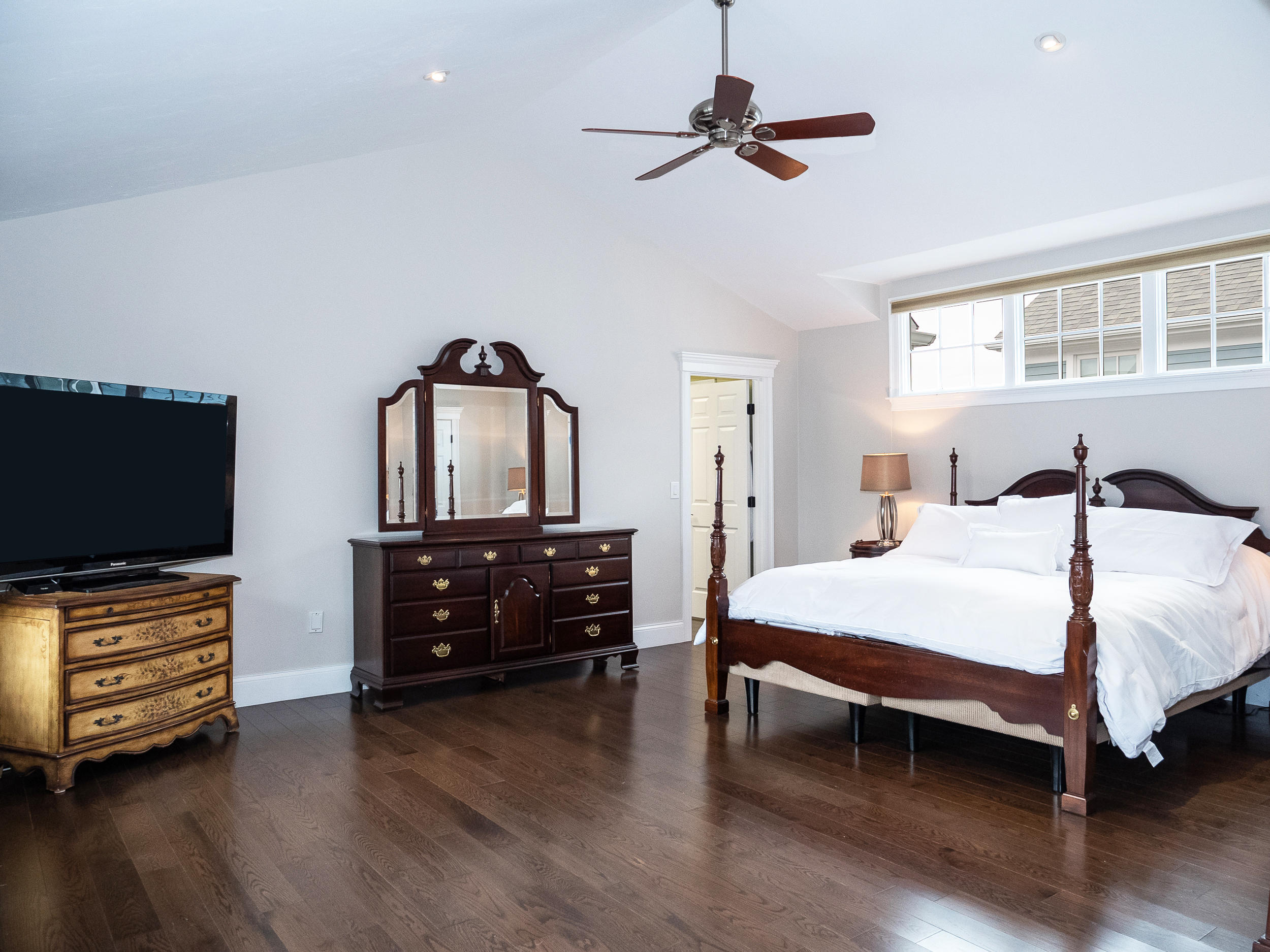 7 Preston Square, Unit 7 Quincy, MA 02171 - Photo 20 of 30 a bedroom with a bed and wooden floor