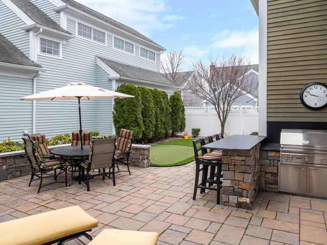 a view of a patio with a table and chairs
