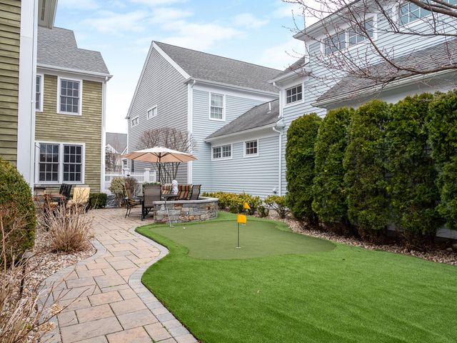 a view of a house with backyard sitting area and garden