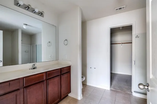 a bathroom with a double vanity sink and mirror