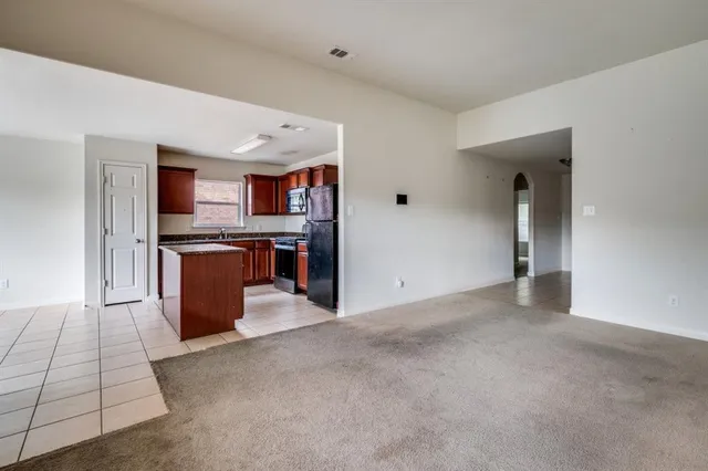 a view of a kitchen with stainless steel appliances granite countertop lots of counter top space and cabinets