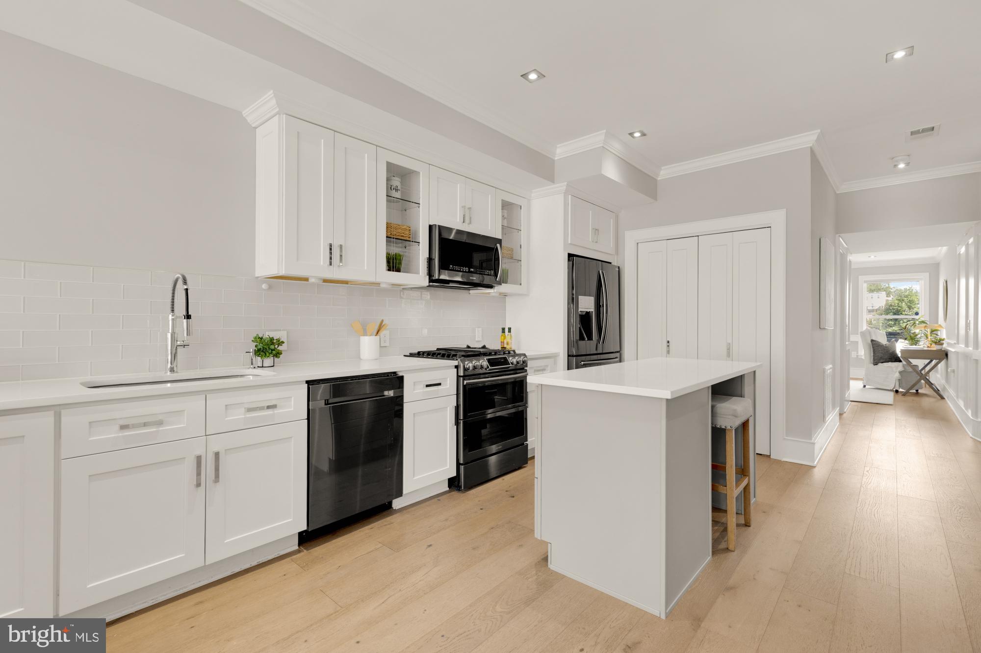 1735 1st Street Northwest, Unit 2 Washington, DC 20001 - Photo 6 of 38 a kitchen with stainless steel appliances white cabinets and a stove top oven