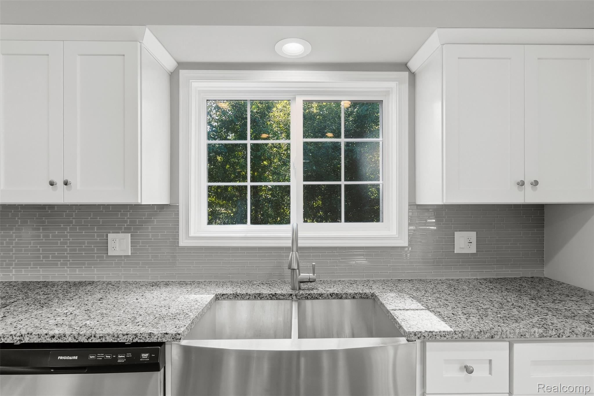 1750 Henbert Road West Bloomfield, MI 48324 - Photo 15 of 32 White shaker-style cabinetry, granite countertops, stainless steel farmhouse sink, tile backsplash, and recessed lighting