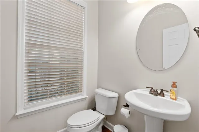 a bathroom with a sink a mirror and a toilet