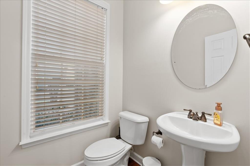 4740 Shiloh Crossing Way Cumming, GA 30040 - Photo 11 of 25 a bathroom with a sink a mirror and a toilet