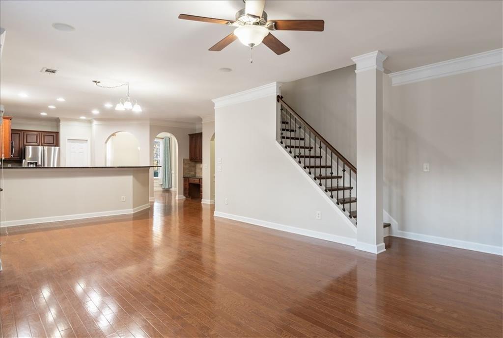 4740 Shiloh Crossing Way Cumming, GA 30040 - Photo 13 of 25 a view of a hallway with wooden floor and a kitchen