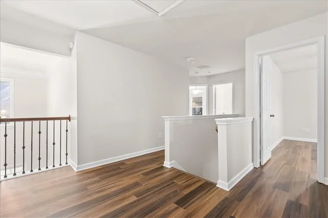 a view of a room with wooden floor