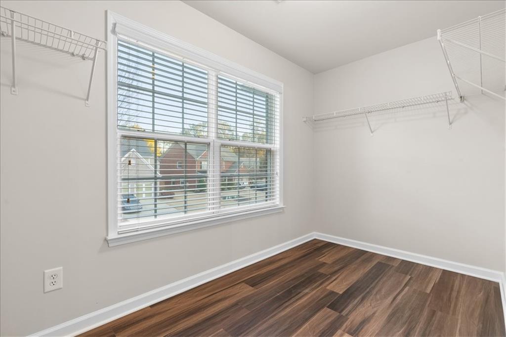 4740 Shiloh Crossing Way Cumming, GA 30040 - Photo 19 of 25 a view of a room with wooden floor and windows