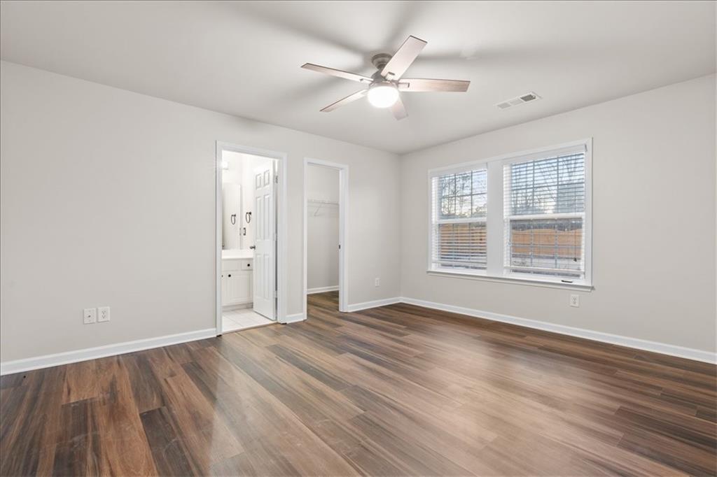 4740 Shiloh Crossing Way Cumming, GA 30040 - Photo 20 of 25 a view of an empty room with wooden floor and a window