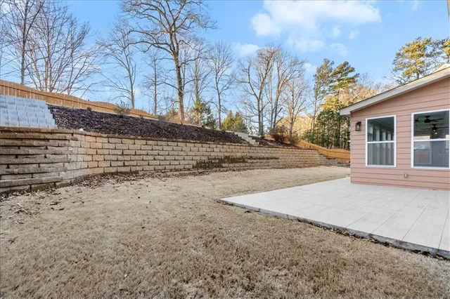 a view of a yard with a house and a tree