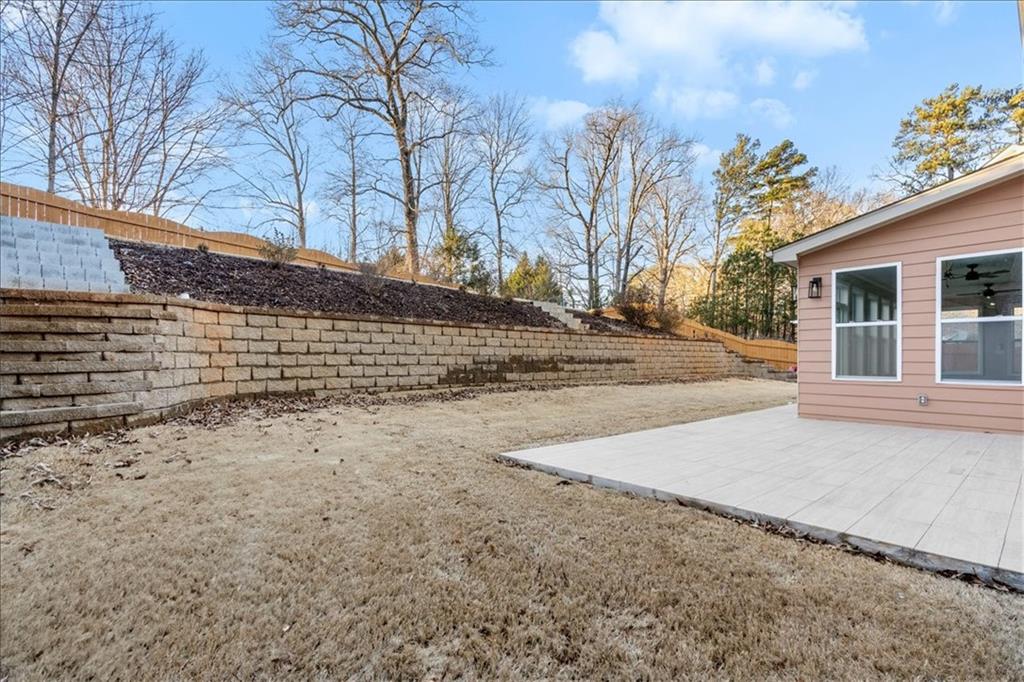 4740 Shiloh Crossing Way Cumming, GA 30040 - Photo 3 of 25 a view of a yard with a house and a tree