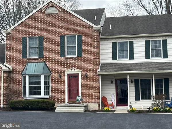 front view of brick house with a small yard