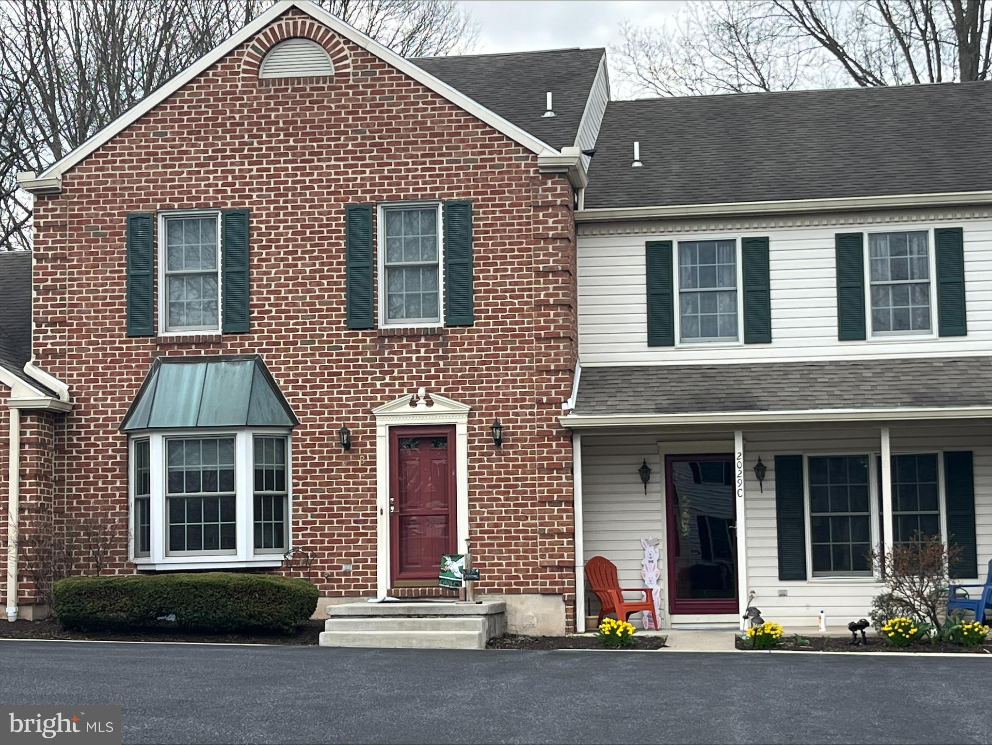 front view of brick house with a small yard