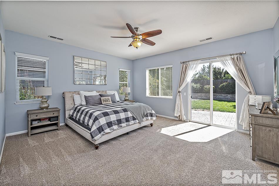 1578 Gemtown Court Reno, NV 89521 - Photo 11 of 25 a spacious bedroom with a bed and glass door