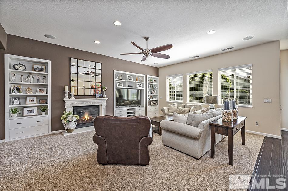 1578 Gemtown Court Reno, NV 89521 - Photo 5 of 25 a living room with furniture a fireplace and a flat screen tv
