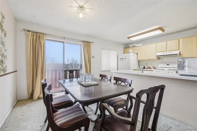 a view of a dining room with furniture and window