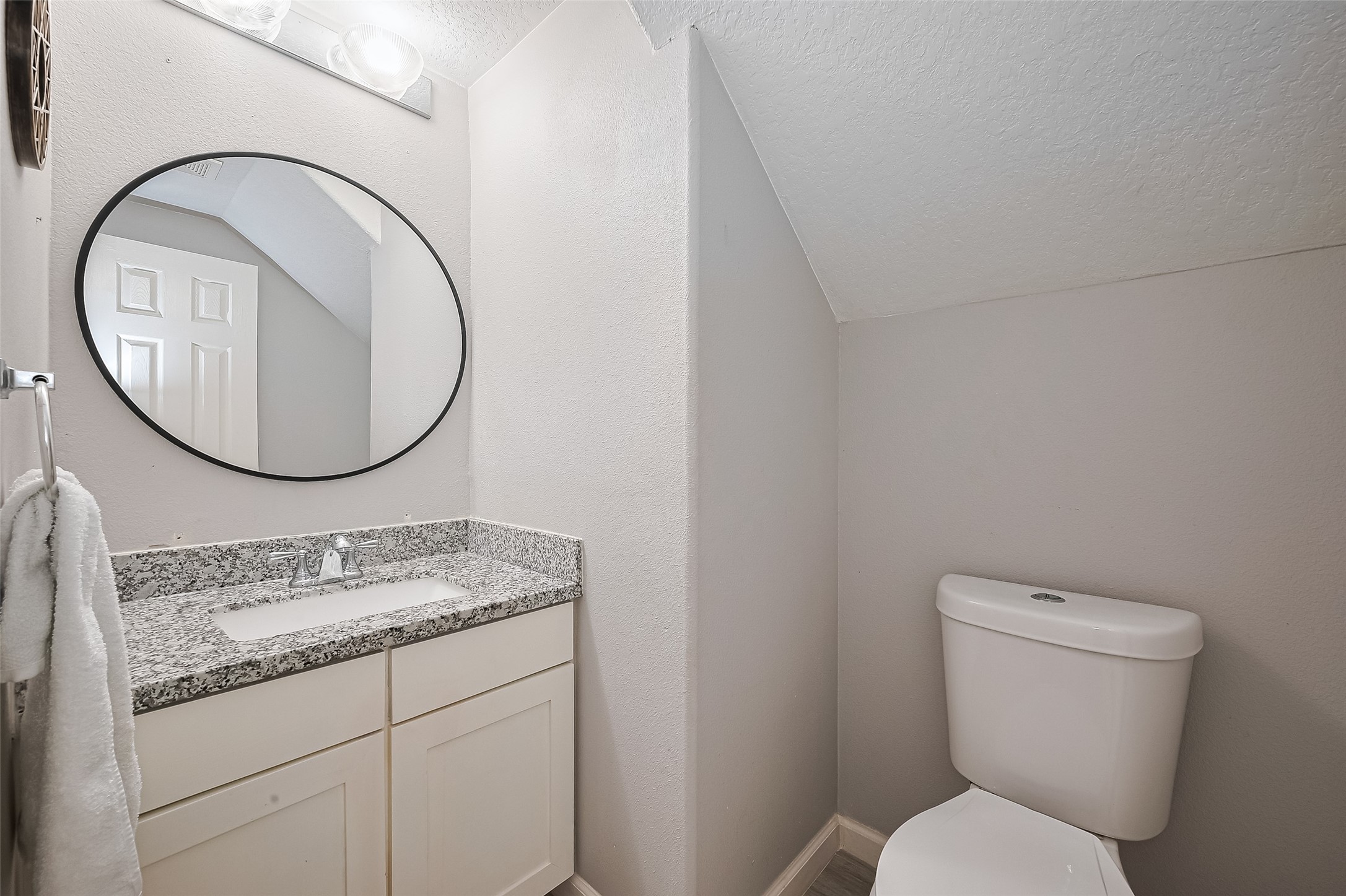 723 Pine Thicket Court Spring, TX 77373 - Photo 19 of 40 a bathroom with a granite countertop toilet a sink and a mirror
