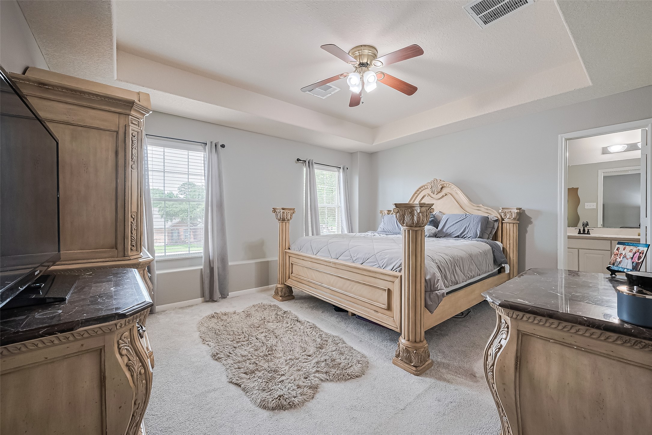 723 Pine Thicket Court Spring, TX 77373 - Photo 29 of 40 a bedroom with a bed and a chandelier