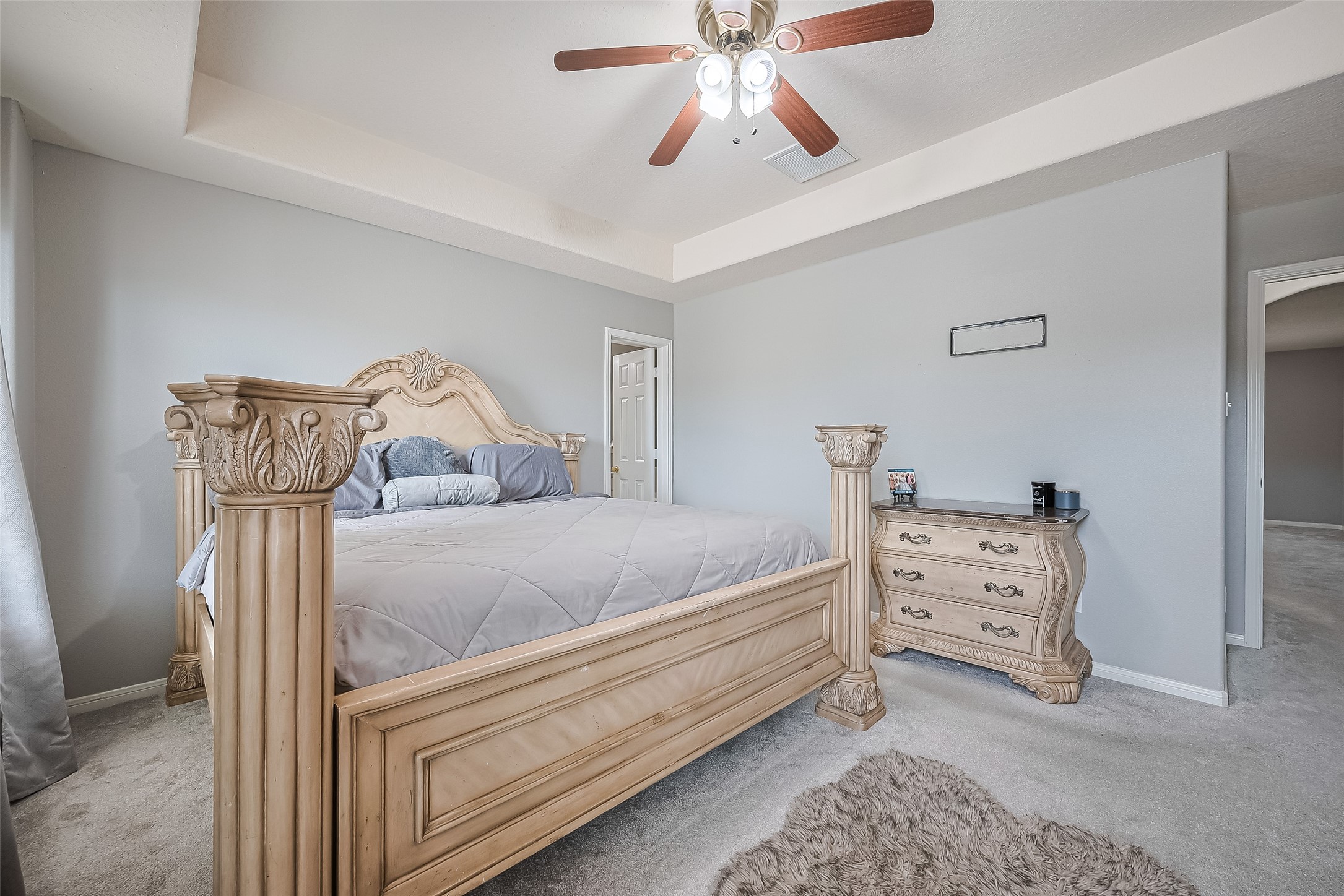 723 Pine Thicket Court Spring, TX 77373 - Photo 30 of 40 a bedroom with a bed and a chandelier