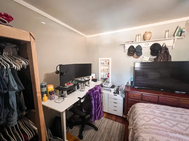 a bedroom with a bed and flat screen tv