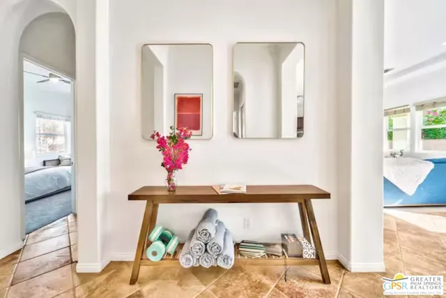 a bedroom with two beds and painting on the wall