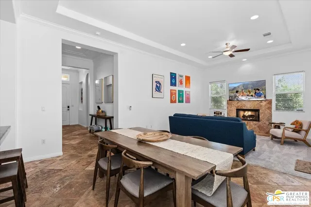 a view of a dining room with furniture and a kitchen