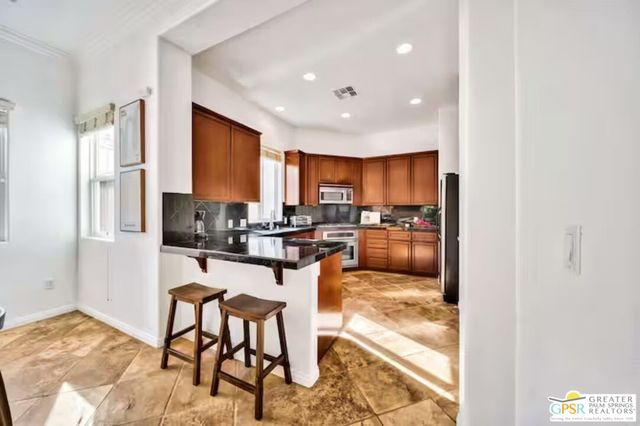 a view of a house with potted plants