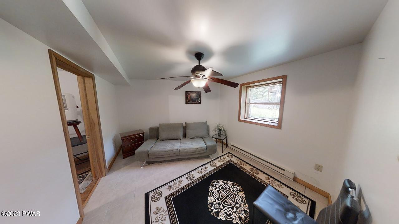 186 Skyview Road Dingmans Ferry, PA 18328 - Photo 25 of 33 a bedroom with a bed and a chandelier