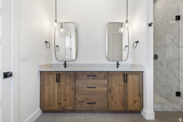 692 East Mountain Road North Ogden, UT 84414 - Photo 8 of 17 Dual wood-finish vanities with light stone countertops, integrated sinks, and matte black hardware