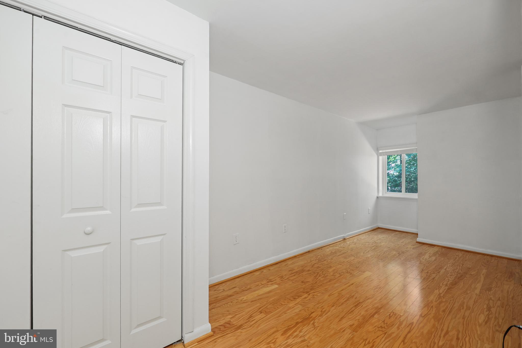 11721 Karbon Hill Court, Unit T2 Reston, VA 20191 - Photo 30 of 31 an empty room with wooden floor and windows